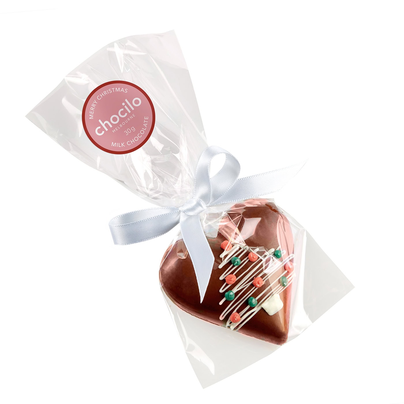 A heart-shaped milk chocolate filled with smooth hazelnut praline, decorated with a Christmas pattern, individually wrapped in clear cellophane with a white ribbon.