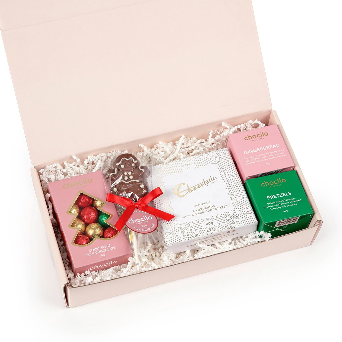 Chocilo Melbourne Gift hamper containing a gingerbread milk chocolate gift cube, pretzel gift cube, Chocolatier Australia mini treat gift box, milk chocolate baubles gift box, and a handmade milk chocolate gingerbread lollipop.