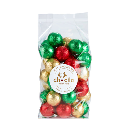 Chocilo Melbourne gift bag containing assorted foil-wrapped milk chocolate baubles in red, green, gold, and silver colors.