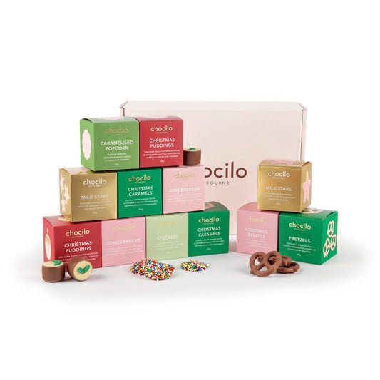 A Chocilo Melbourne Christmas Gift Hamper filled with 12 chocolate treat gift cubes. The treats include chocolate Stars, Christmas Caramels, Christmas Gingerbread, Christmas Plum Pudding, Liquorice Bullets, Speckles, Caramelised Popcorn, and Pretzels.