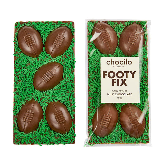 Chocilo Melbourne Footy Fix premium milk chocolate block with solid milk chocolate footballs and green speckles.