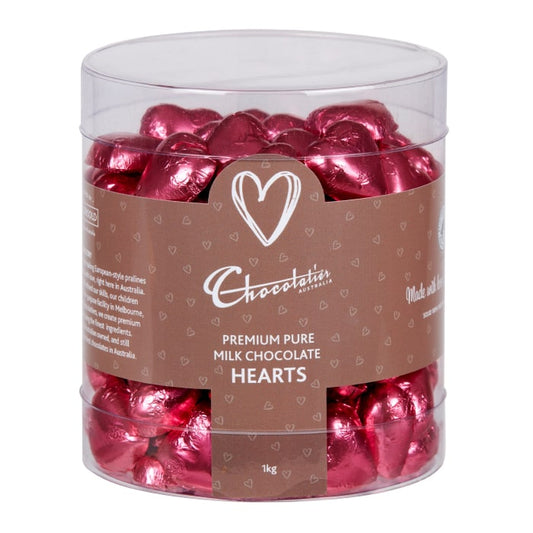 Chocolatier Australia Pink Foiled Hearts in Milk Chocolate. Packed into a clear tub for display.